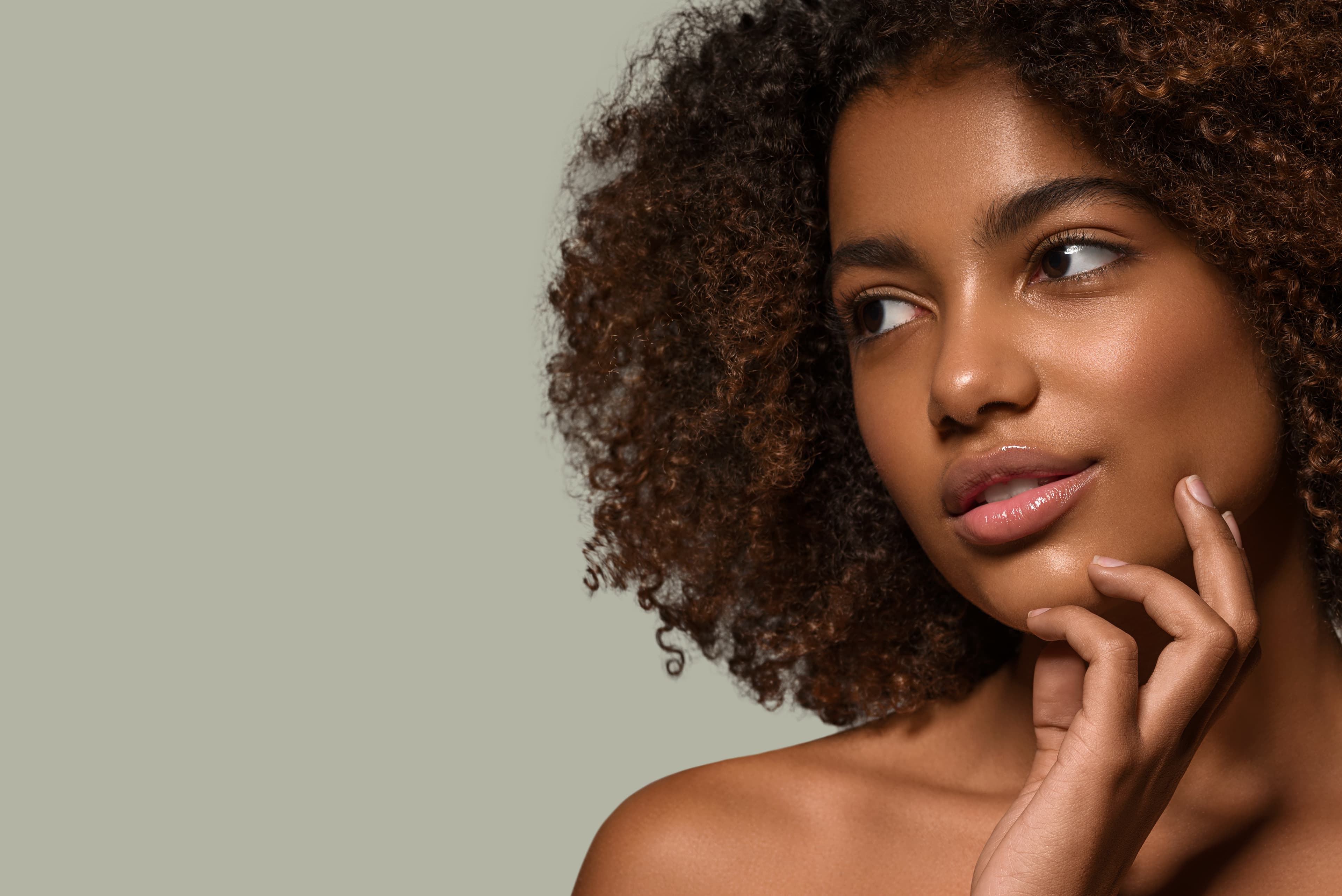 beautiful-african-woman-black-t-shirt-portrait-afro-haircut-touching-her-face-color-background-green